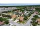 An aerial view of a residential community showcasing well-maintained homes with mature trees and landscaping under a blue sky at 4706 Josselin Pl, Parrish, FL 34219