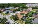 A neighborhood aerial view features a house with a screened-in pool next to a pond on a sunny day at 4706 Josselin Pl, Parrish, FL 34219