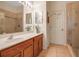 Bathroom featuring a wood vanity, double mirror, a walk-in shower with glass door, and tiled flooring at 4706 Josselin Pl, Parrish, FL 34219