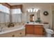 Relaxing bathroom with tub, vanity, decorative accents, and window at 4706 Josselin Pl, Parrish, FL 34219