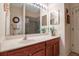 Bathroom with a wood vanity, double mirror, a walk-in shower with glass door, and tiled flooring at 4706 Josselin Pl, Parrish, FL 34219