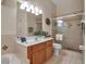 Bright bathroom boasts a glass-enclosed shower and wooden vanity at 4706 Josselin Pl, Parrish, FL 34219