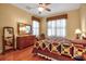 Bedroom with wooden floors, a patterned quilt, and natural light at 4706 Josselin Pl, Parrish, FL 34219