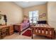 Bedroom with twin beds, carpet, a ceiling fan, a window, and a desk with chair at 4706 Josselin Pl, Parrish, FL 34219