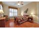 Cozy bedroom with wooden floors, a patchwork quilt, and natural lighting at 4706 Josselin Pl, Parrish, FL 34219