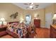 Bright bedroom with wooden floors, quilt, and an en-suite bathroom entrance at 4706 Josselin Pl, Parrish, FL 34219