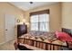 Cozy bedroom with a decorative quilt, window with blinds, and carpeted flooring at 4706 Josselin Pl, Parrish, FL 34219