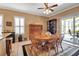 Cozy dining area with a round table, wooden chairs, and a view of the outdoor space at 4706 Josselin Pl, Parrish, FL 34219