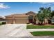 Inviting home exterior featuring a two-car garage, spacious driveway, and lush landscaping enhancing its curb appeal at 4706 Josselin Pl, Parrish, FL 34219