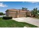 Charming single-story home featuring a two-car garage, well-manicured lawn, and an American flag displayed near the entrance at 4706 Josselin Pl, Parrish, FL 34219