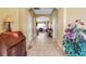 A wide foyer with tile floors leads into a beautiful living area, showcasing the home's open floor plan and design at 4706 Josselin Pl, Parrish, FL 34219