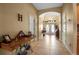 Inviting foyer featuring tiled flooring, a decorative archway, and a charming antique sewing table at 4706 Josselin Pl, Parrish, FL 34219