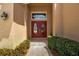 Inviting front entrance with double doors, transom window, and a tidy landscape creating curb appeal at 4706 Josselin Pl, Parrish, FL 34219