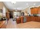 Well-appointed kitchen with wooden cabinetry, granite countertops, and open layout at 4706 Josselin Pl, Parrish, FL 34219