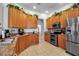 Spacious kitchen features wooden cabinetry, ample countertop space, and modern appliances at 4706 Josselin Pl, Parrish, FL 34219