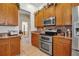 Well-equipped kitchen boasts stainless steel appliances, a double oven, and ample cabinet space at 4706 Josselin Pl, Parrish, FL 34219