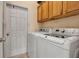 Functional laundry room featuring a modern washer and dryer, ample cabinet storage, and convenient access at 4706 Josselin Pl, Parrish, FL 34219