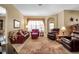 Comfortable living room with an area rug, two couches, two recliner chairs, lamps, and decorations at 4706 Josselin Pl, Parrish, FL 34219
