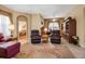 Comfortable living room with an area rug, two couches, two recliner chairs, lamps, and decorations at 4706 Josselin Pl, Parrish, FL 34219