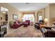 Comfortable living room with an area rug, two couches, two recliner chairs, lamps, and decorations at 4706 Josselin Pl, Parrish, FL 34219