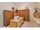 Versatile office space with built-in shelving, a sewing table, and neutral decor at 4706 Josselin Pl, Parrish, FL 34219