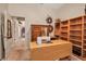 Spacious office area with sewing table, plenty of shelving, and a view to the hallway at 4706 Josselin Pl, Parrish, FL 34219
