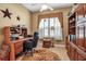 Home office space with wooden desk, built-in shelving, and natural light at 4706 Josselin Pl, Parrish, FL 34219