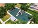 Top down view of a community playground with swings, slides, and play equipment near a pond at 4706 Josselin Pl, Parrish, FL 34219