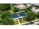 Aerial view of community playground with slides and play equipment with trees and a pond in the background at 4706 Josselin Pl, Parrish, FL 34219