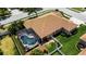 Aerial view of a pool inside a screened enclosure with a fountain and patio furniture and a manicured green yard at 4706 Josselin Pl, Parrish, FL 34219