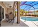 Enjoy the outdoors on this screened-in patio featuring an outdoor dining set with a lovely view of the pool area at 4706 Josselin Pl, Parrish, FL 34219