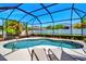 Relax on the sun loungers on this patio within the screened-in enclosure of this beautiful pool at 4706 Josselin Pl, Parrish, FL 34219