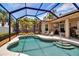 The large pool and lush backyard create a private oasis in this screened-in enclosure that also features a covered patio at 4706 Josselin Pl, Parrish, FL 34219
