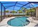 Relaxing screened-in pool area with clear blue water, lounge chairs, and lush landscaping for privacy at 4706 Josselin Pl, Parrish, FL 34219