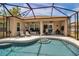 Enjoy the luxury of this large, screened-in pool with steps, sun loungers, and outdoor dining in the covered patio at 4706 Josselin Pl, Parrish, FL 34219