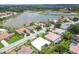 Scenic aerial view of a residential neighborhood with a beautiful lake backdrop at 5106 Far Oak Cir, Sarasota, FL 34238