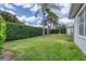 Lush backyard with privacy hedge and tropical trees offering a serene outdoor space at 5106 Far Oak Cir, Sarasota, FL 34238