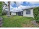 Spacious backyard with lush green lawn and privacy hedge at 5106 Far Oak Cir, Sarasota, FL 34238