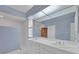 Bright bathroom with double sinks, white cabinetry, and glass encased shower stall at 5106 Far Oak Cir, Sarasota, FL 34238
