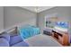 Comfortable bedroom with a daybed, lounge chair, and a mounted flat screen television at 5106 Far Oak Cir, Sarasota, FL 34238