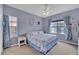 Cozy bedroom with blue accent wall and natural light streaming through the windows at 5106 Far Oak Cir, Sarasota, FL 34238