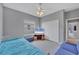 Bright bedroom featuring a ceiling fan, large window, and neutral color scheme at 5106 Far Oak Cir, Sarasota, FL 34238