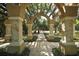 Scenic walking path through a community pergola surrounded by lush greenery and shade trees for a peaceful ambiance at 5106 Far Oak Cir, Sarasota, FL 34238