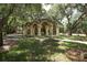 Picturesque pergola with stone pillars in a tranquil community area, perfect for outdoor relaxation and gatherings at 5106 Far Oak Cir, Sarasota, FL 34238