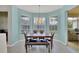 Bright dining area with large windows, tile floors, and a modern chandelier above the wood table set at 5106 Far Oak Cir, Sarasota, FL 34238