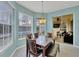 Dining area featuring a dark wood table set and view to the outdoor patio via sliding glass doors at 5106 Far Oak Cir, Sarasota, FL 34238