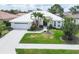 Beautiful single-story home features a white tile roof, two-car garage, and mature landscaping at 5106 Far Oak Cir, Sarasota, FL 34238
