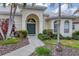 A home's front entrance has well maintained landscaping and a curved sidewalk up to the front door at 5106 Far Oak Cir, Sarasota, FL 34238