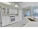 Stylish kitchen with stainless steel appliances, white cabinetry, and stone countertops at 5106 Far Oak Cir, Sarasota, FL 34238