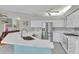 Open kitchen with white cabinets, stainless steel appliances, and stone countertops at 5106 Far Oak Cir, Sarasota, FL 34238